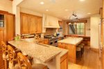 The chefs kitchen with granite counters, custom cabinetry, oversized Viking gas range, wine fridge, ice maker and custom hood range make whipping up delicious meals easy